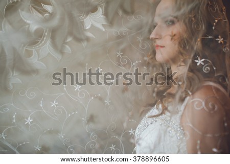 beautiful bride at a window at home