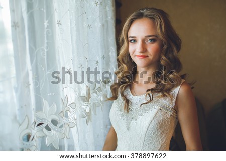 beautiful bride at a window at home