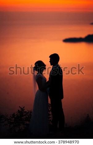 Silhouettes of couples near Sveti Stefan