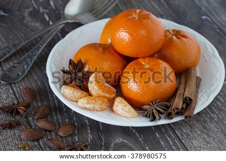 ripe tangerine in a white plate on the table