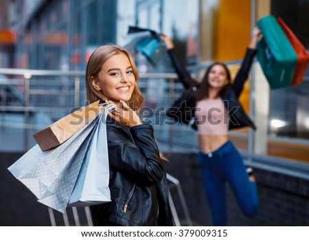 beautiful girls with shopping bags in ctiy Royalty-Free Stock Photo #379009315