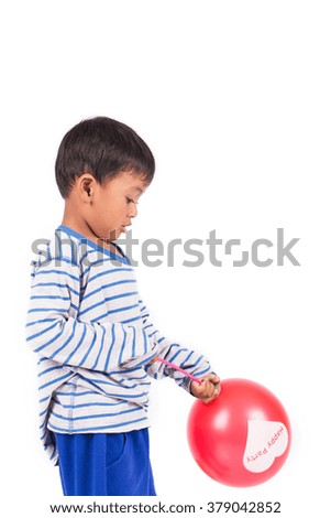 happy cute little boy play with red balloon