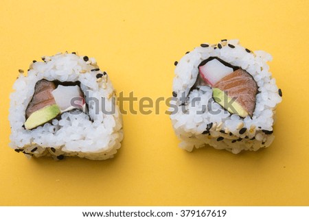 Various kinds of sushi food served on yellow blackground