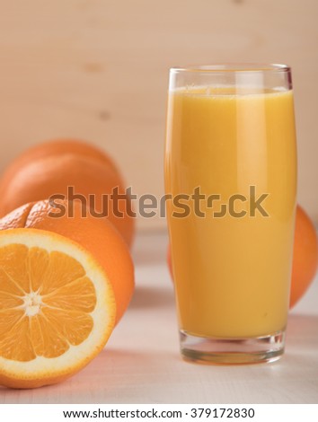fresh orange juice with oranges on table