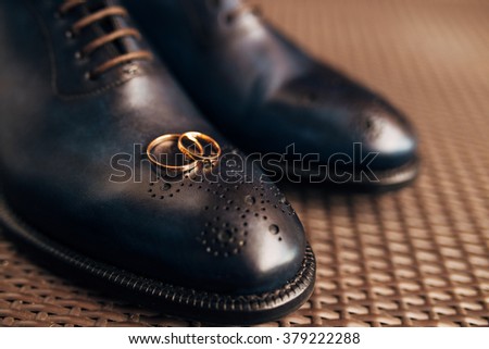 Men's black shoes on the floor