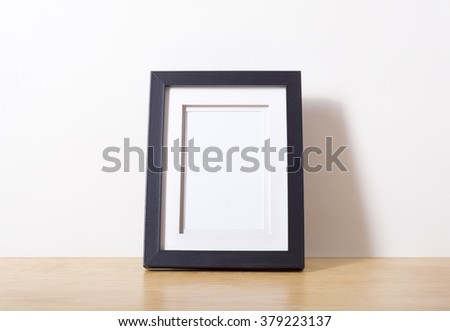 Small black picture frame on desk