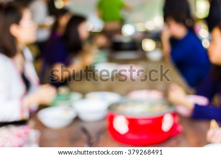 Blur image of eating among friends,use for background.