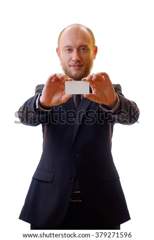 Young businessman in a black suit, shirt and tie shows his new business card. The template for the presentation of business cards or company logo.
Man gives his business card at a meeting.