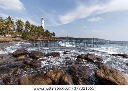 Dondra Head Lighthouse, Sri Lanka. One of the tallest in South East Asia. Beautiful landscape tropical rocky beach.