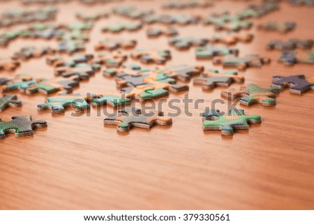 Puzzles on a wooden surface closeup