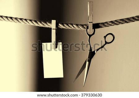 Hairdressing scissors over the rope with clip
