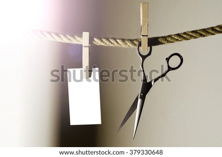 Hairdressing scissors over the rope with clip