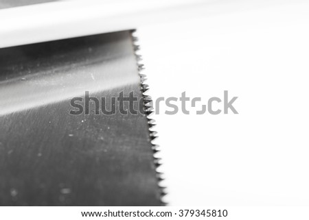 Close up a part of saw blade teeth isolated on white background. Blade of saw.