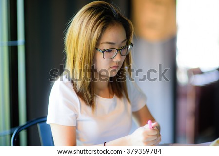 education concept - indoor picture of bored and tired woman taking notes