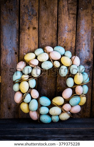 Easter eggs wreath on rustic wooden background