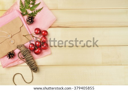 wooden table,things on the table blank and cherry with envelope, brushes, 