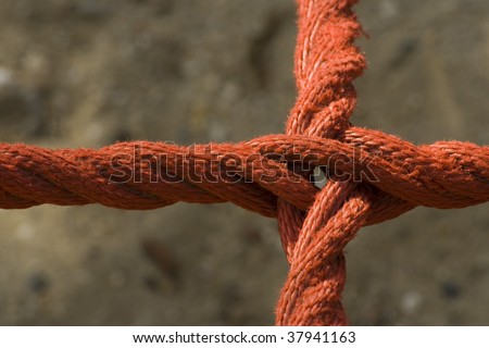 Red rope in the shape of a cross Royalty-Free Stock Photo #37941163
