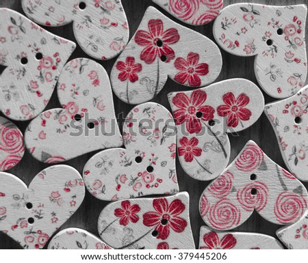Many beautiful painted wooden buttons in the shape of a heart in vintage style, postcard 