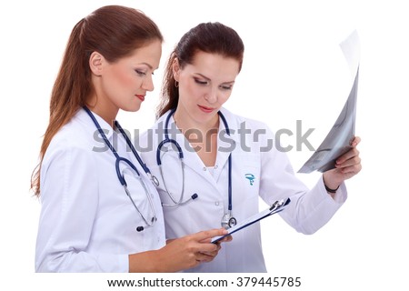 Two woman nurse watching X Ray image, standing in hospital