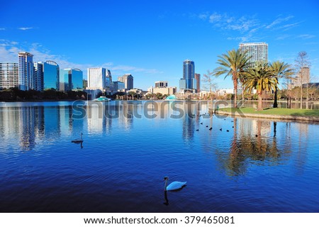 Orlando Lake Eola in the morning with urban skyscrapers and clear blue sky with swan. Royalty-Free Stock Photo #379465081