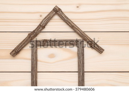 House made of branches, nature architecture, on wood background