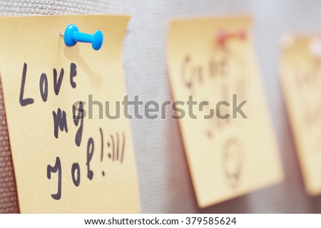 Adhesive note with Love my job text on a bulletin board