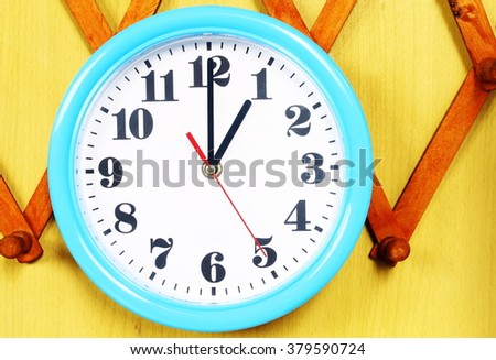 One o'clock on the blue wall clocks Royalty-Free Stock Photo #379590724