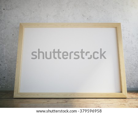 Blank picture frame on wooden table, close up