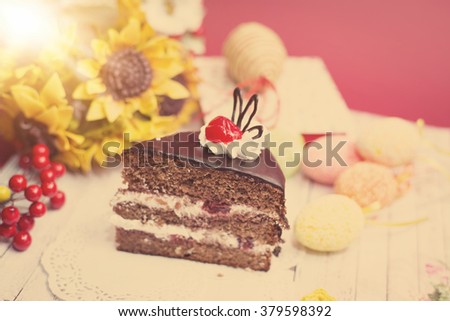 Close up on set of cake, colorful eggs and gift decorations