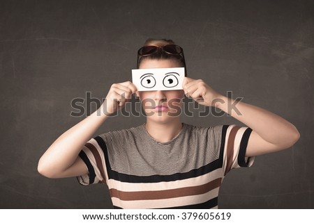 Funny woman looking with hand drawn paper eyes concept
