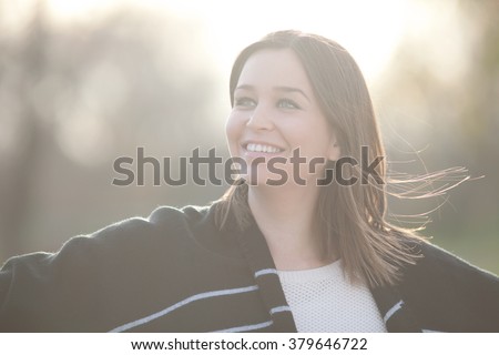 Outdoor portrait of beautiful young woman, shallow depth of field