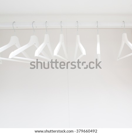 wooden coat hangers on clothes rail