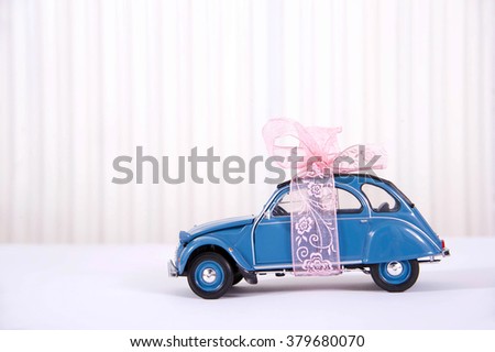Miniature car with pink ribbon