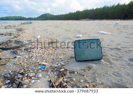 Old Television on a beach, environmental pollution concept picture.