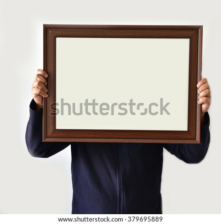 A Man holding real picture frame isolated on white background , with lot of empty space for text