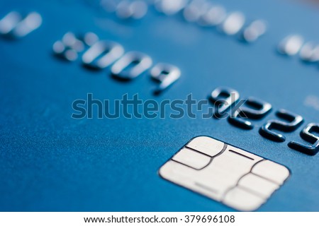 Credit card in blue with chip close up atm emv blurred Royalty-Free Stock Photo #379696108