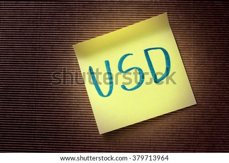 USD (American Dollar) acronym on yellow sticky note