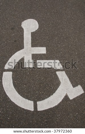 Handicap sign on asphalt street