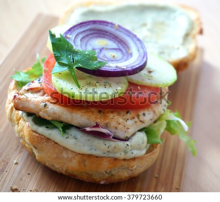 Delicious burger with chicken and vegetables.
