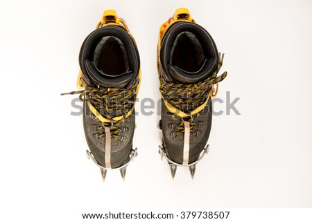  trekking shoes, crampons for mountaineering, isolated on white. Top view. Climbing equipment