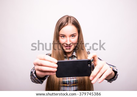 Selfie time. Joyful young women making selfie by her smart phone 