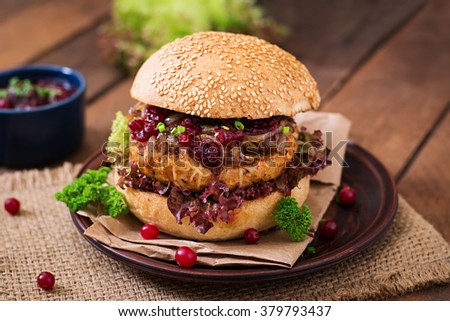 Hamburger with juicy turkey burger with cheese, caramelized onions and cranberry sauce