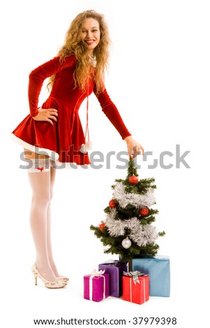 Portrait of pretty snowgirl standing by decorated xmas tree