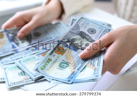 Hands counting money, close up