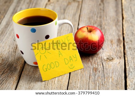 Piece of note paper on grey wooden background