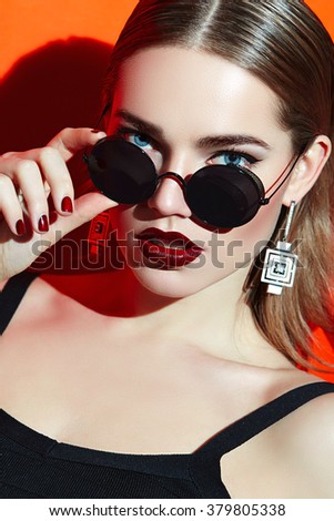 Girl in sunglasses.
The girl with short brown hair, straight hair in sunglasses. Cherry lipstick.