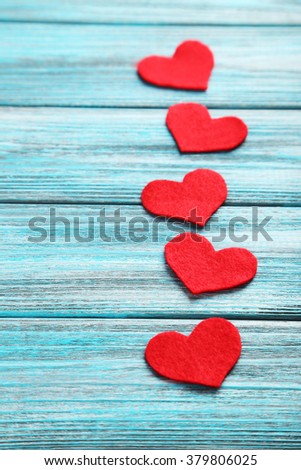Red hearts on a blue wooden table
