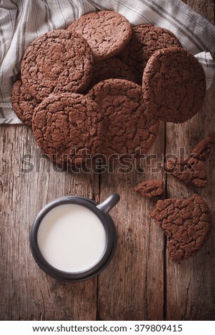chocolate ginger cookies and milk on the table close-up. Vertical top view, rustic
