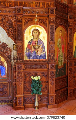 Odessa, Ukraine: Interior of the Orthodox Church, altar, iconostasis, and beautiful historic architectural arches, painted icons, frescoes, bas-reliefs in natural light, gilding