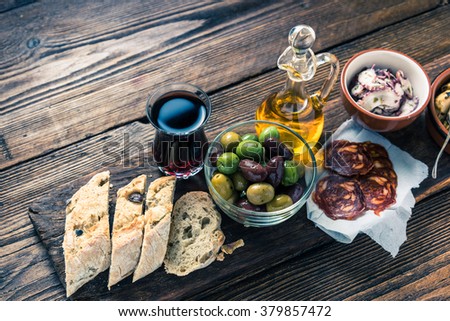 Authentic spanish tapas on wooden board, tonned picture, from above
